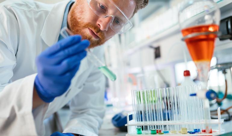 Afbeelding reageerbuizen met laborant